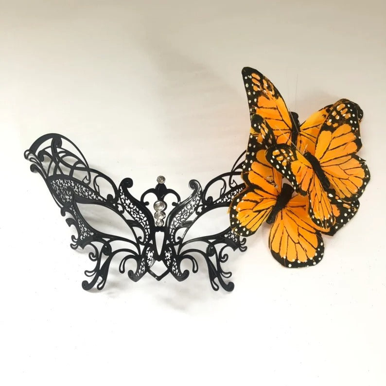 Black filigree masquerade mask with orange monarch butterflies for women.