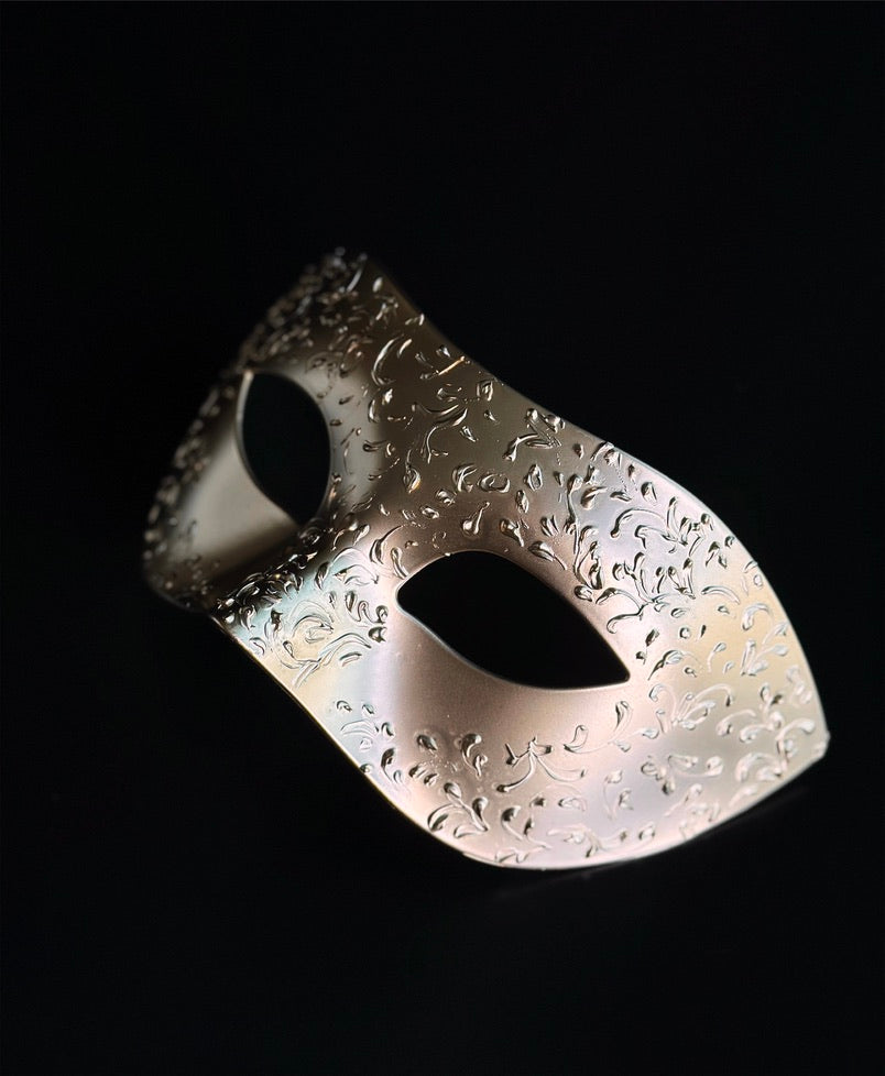 Champagne gold Venetian masquerade mask with embossed floral filigree design.