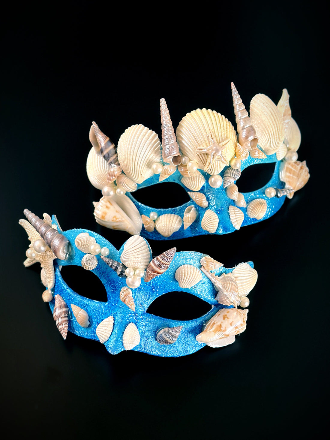Blue couples masquerade masks featuring sea shells, starfish, and pearls