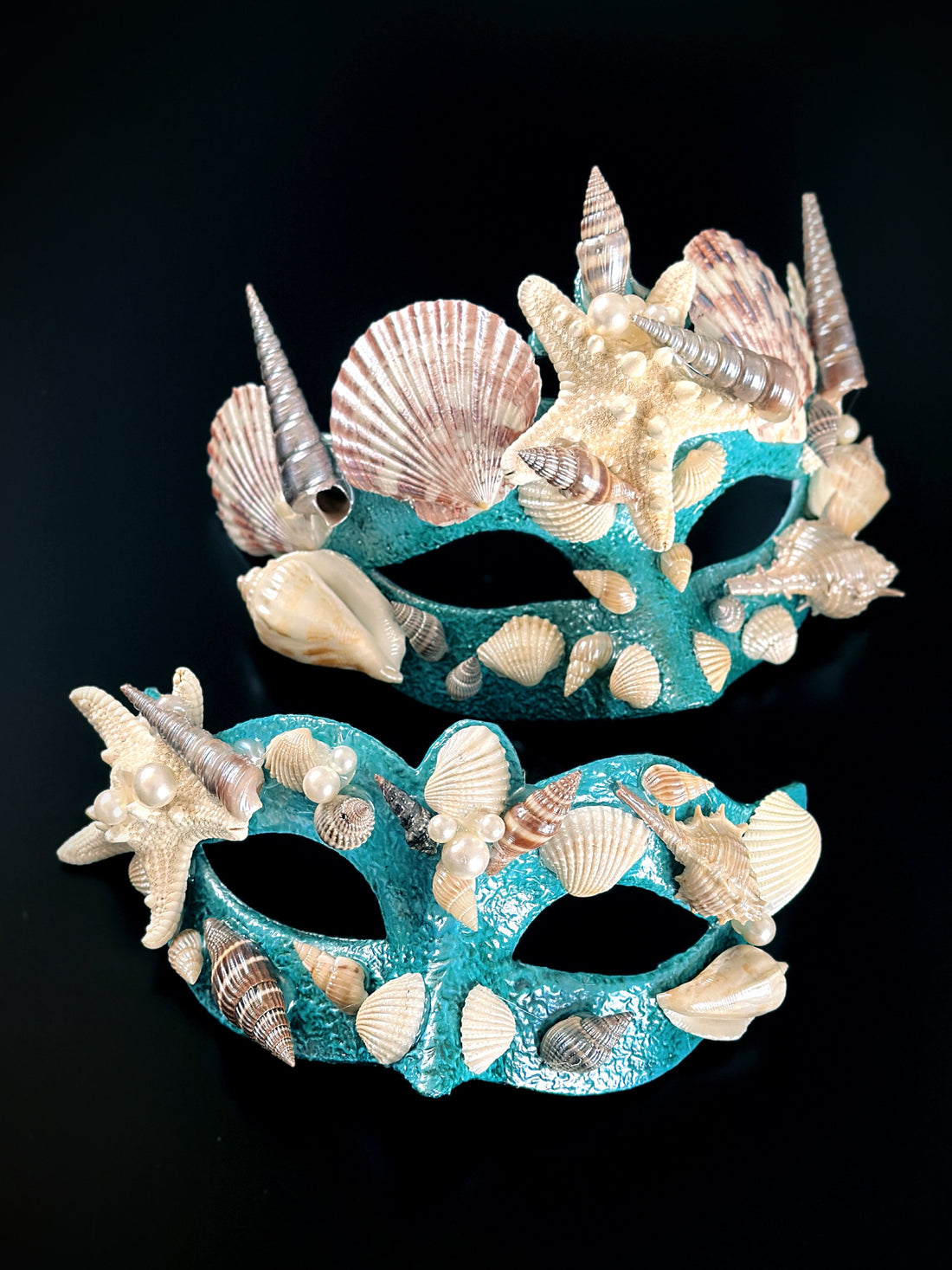 turquoise mermaid masks with shells and pearls.