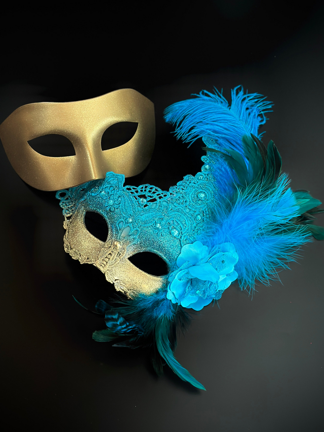 Turquoise gold venetian masquerade masks for couples with glitter, feathers, and gems.
