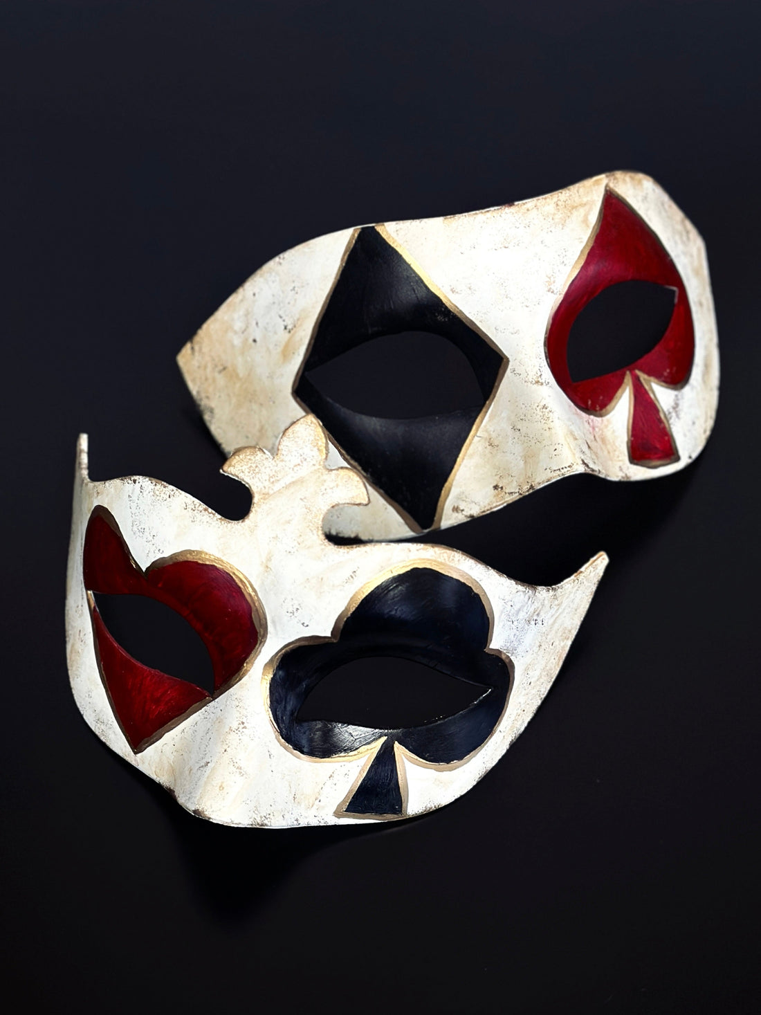 Couples masquerade mask set with black and red card suit symbols over the eyes and gold details.