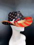 Cowboy hat with a USA flag design featuring stars, stripes, and painted horses in white blue and red.