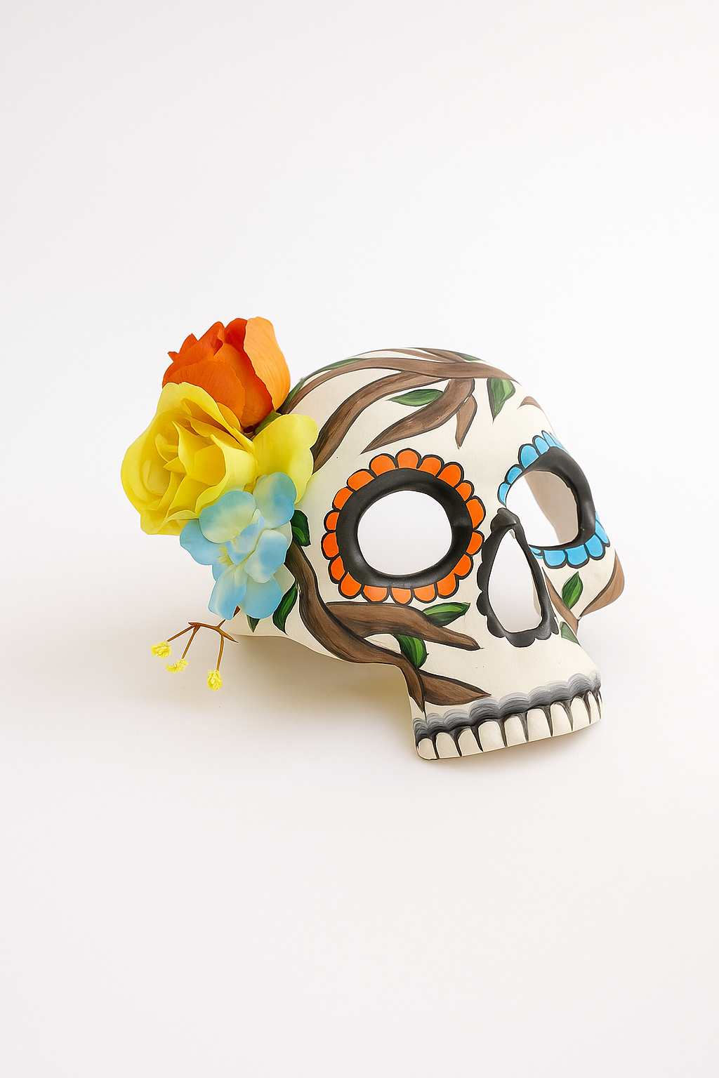Dia de los Muertos skull mask with branch design and colorful side flower crown.