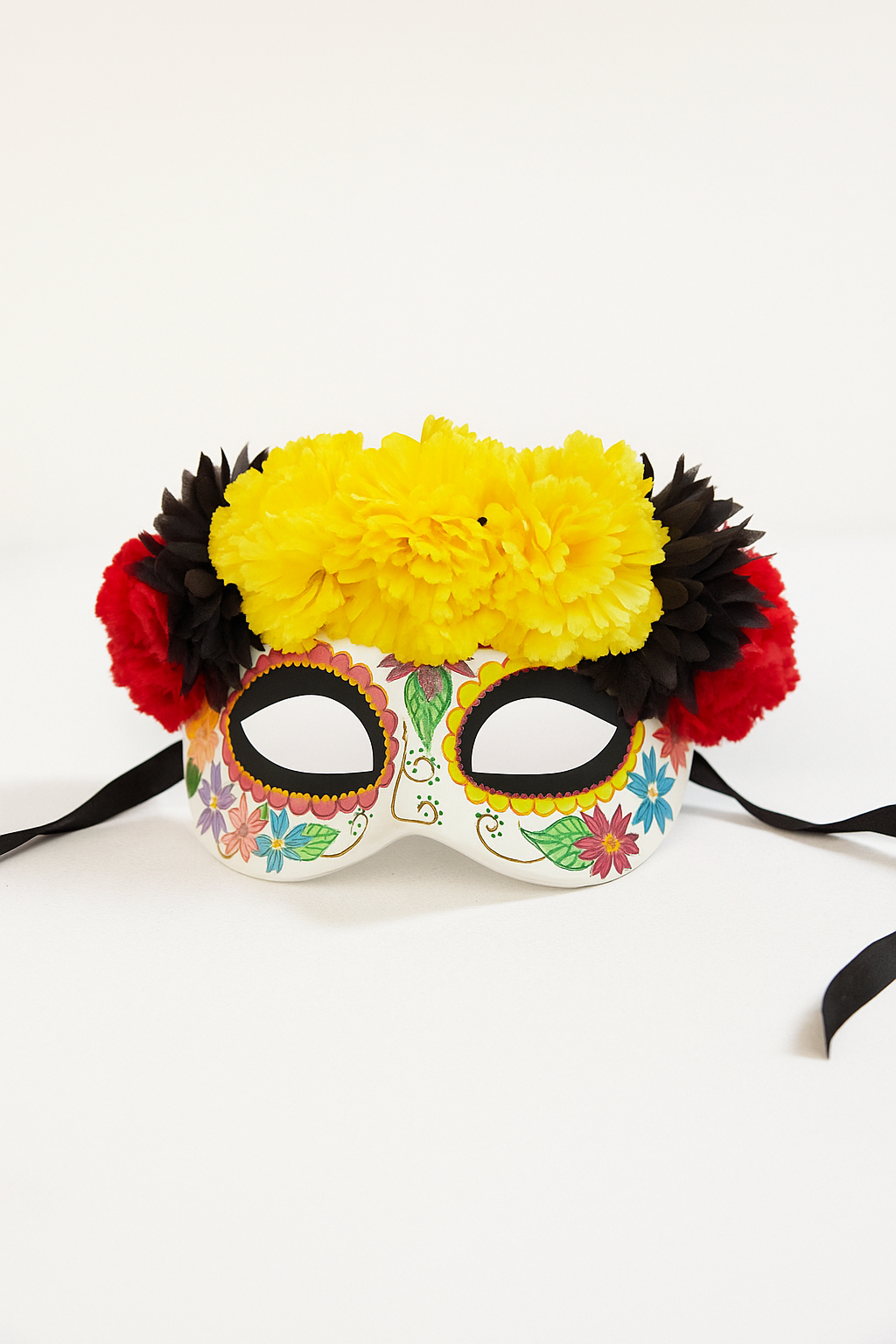Dia de los Muertos sugar skull mask with yellow marigold flower crown and red and black accents.