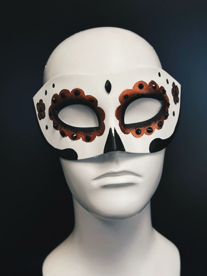 White base mask with copper and black sugar skull details and black gems.