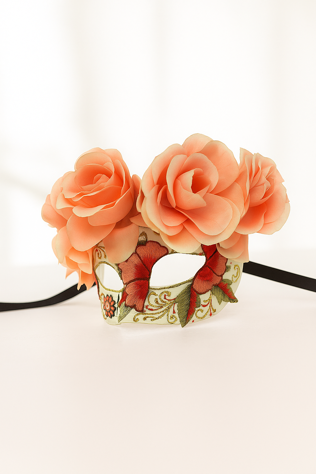 Sugar skull mask with embroidered floral details and peach rose flower crown for Dia de los Muertos.