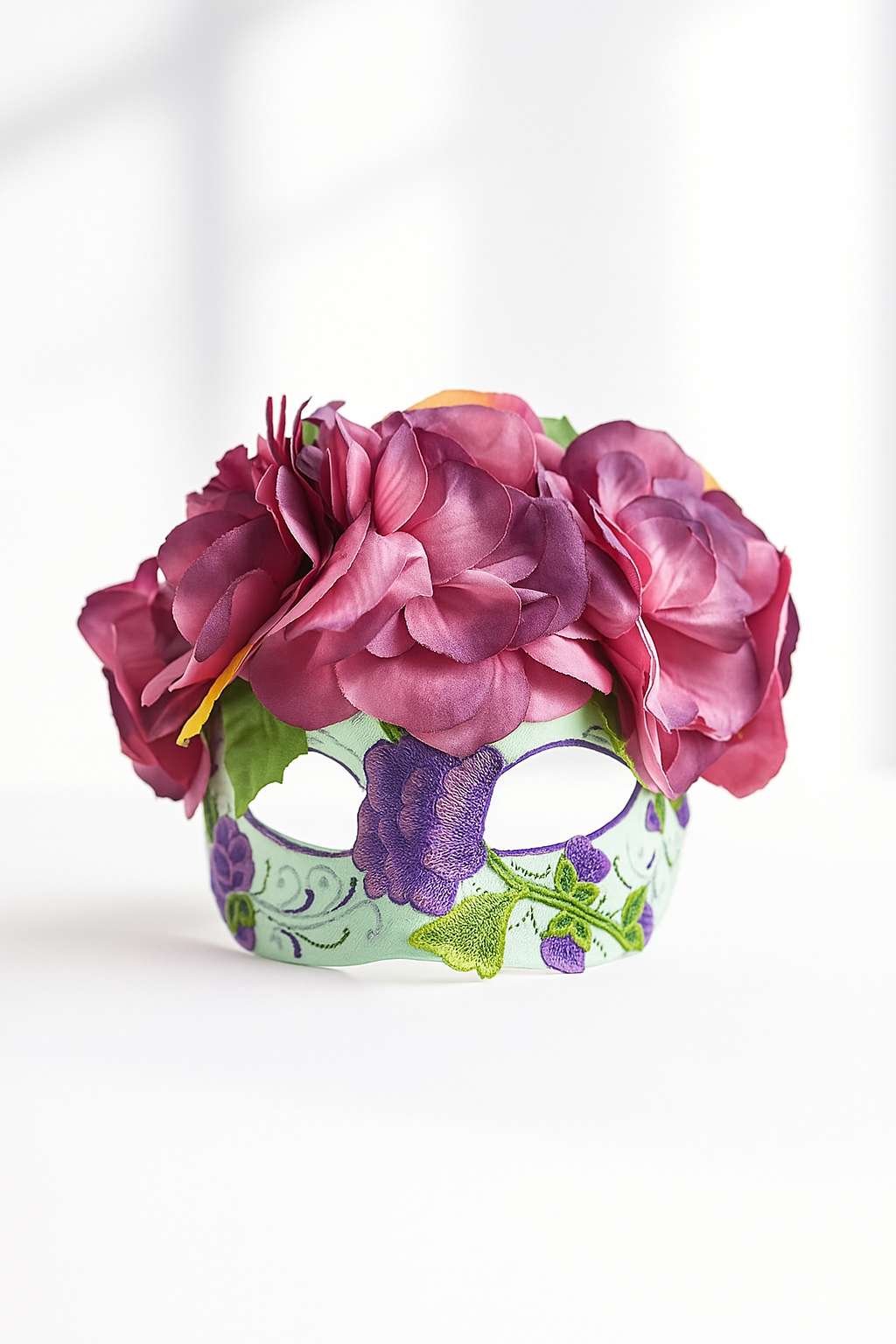 Sugar skull mask with embroidered floral accents and purple rose flower crown for Dia de los Muertos.