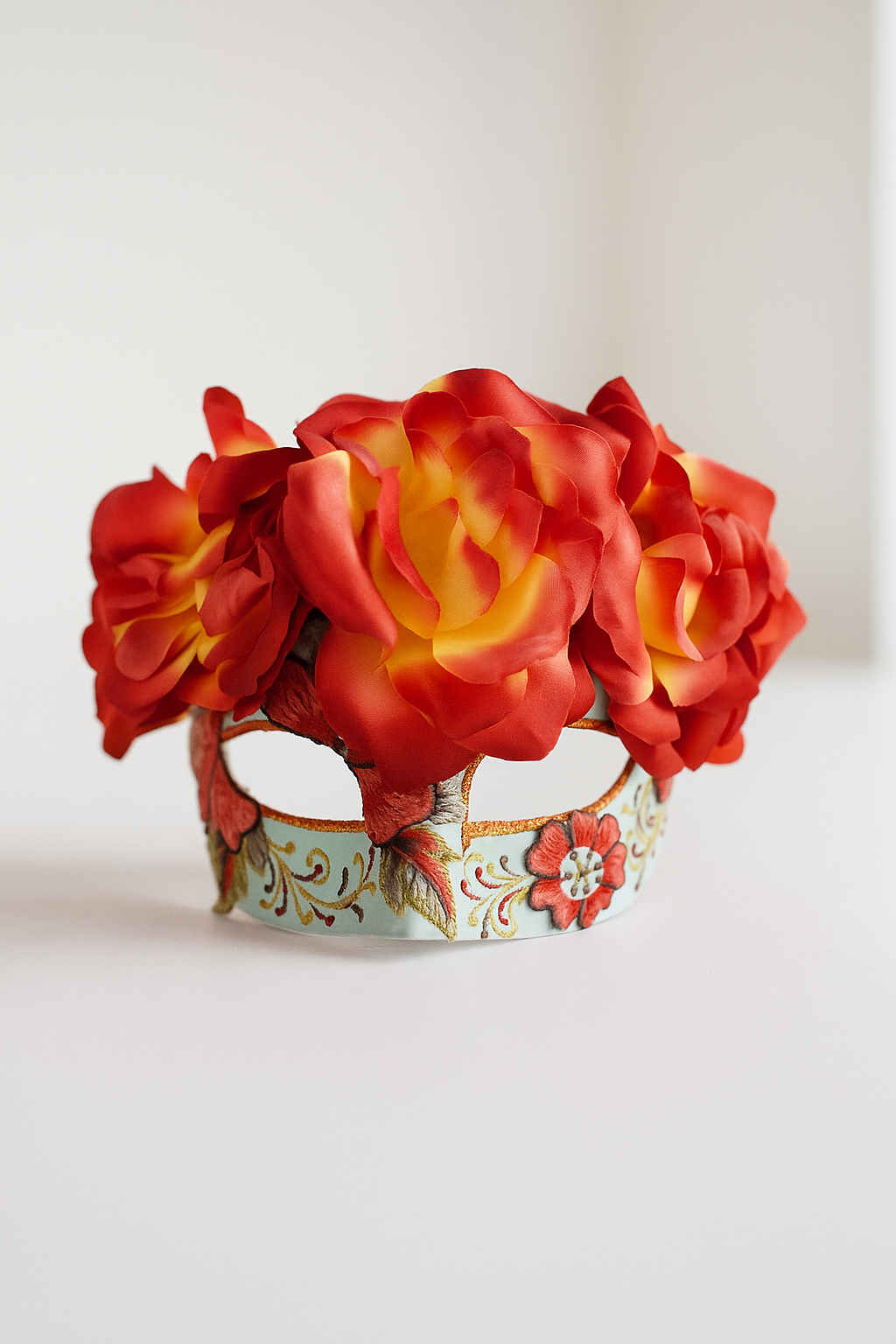 Day of the Dead sugar skull mask with red and yellow flower crown and embroidered floral details.