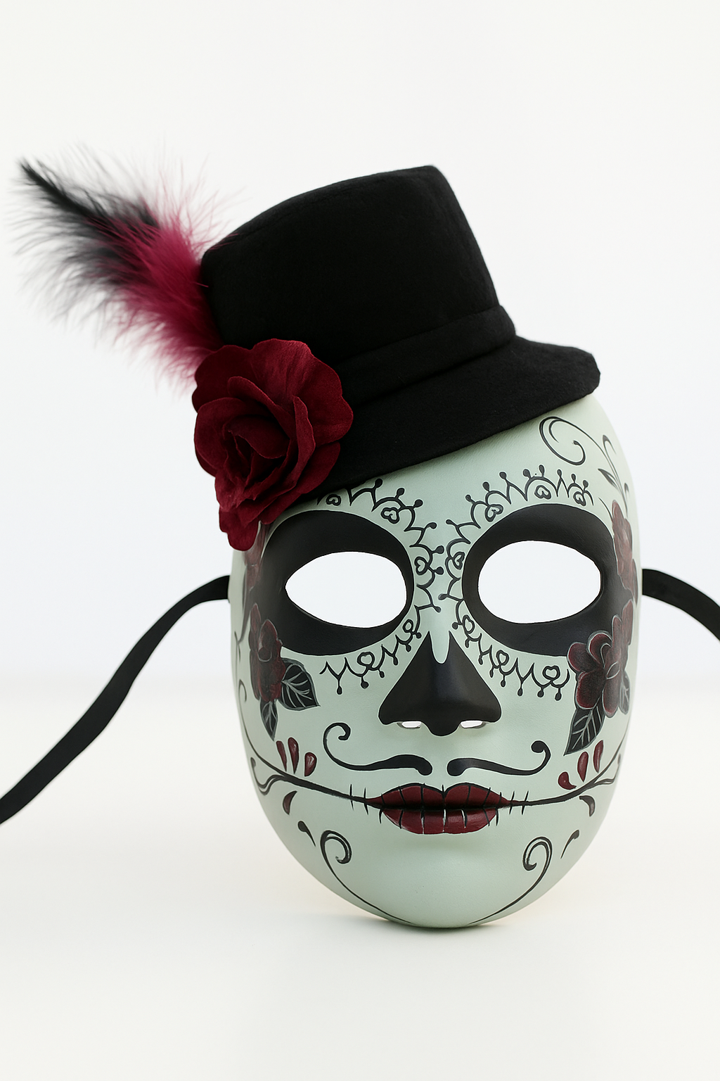 White sugar skull mask with black top hat, rose, and feather.