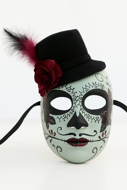 White sugar skull mask with black top hat, rose, and feather.