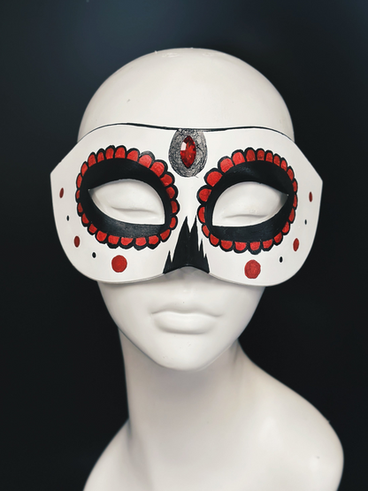 White masquerade mask base with red and black sugar skull details and a red gem in the center.