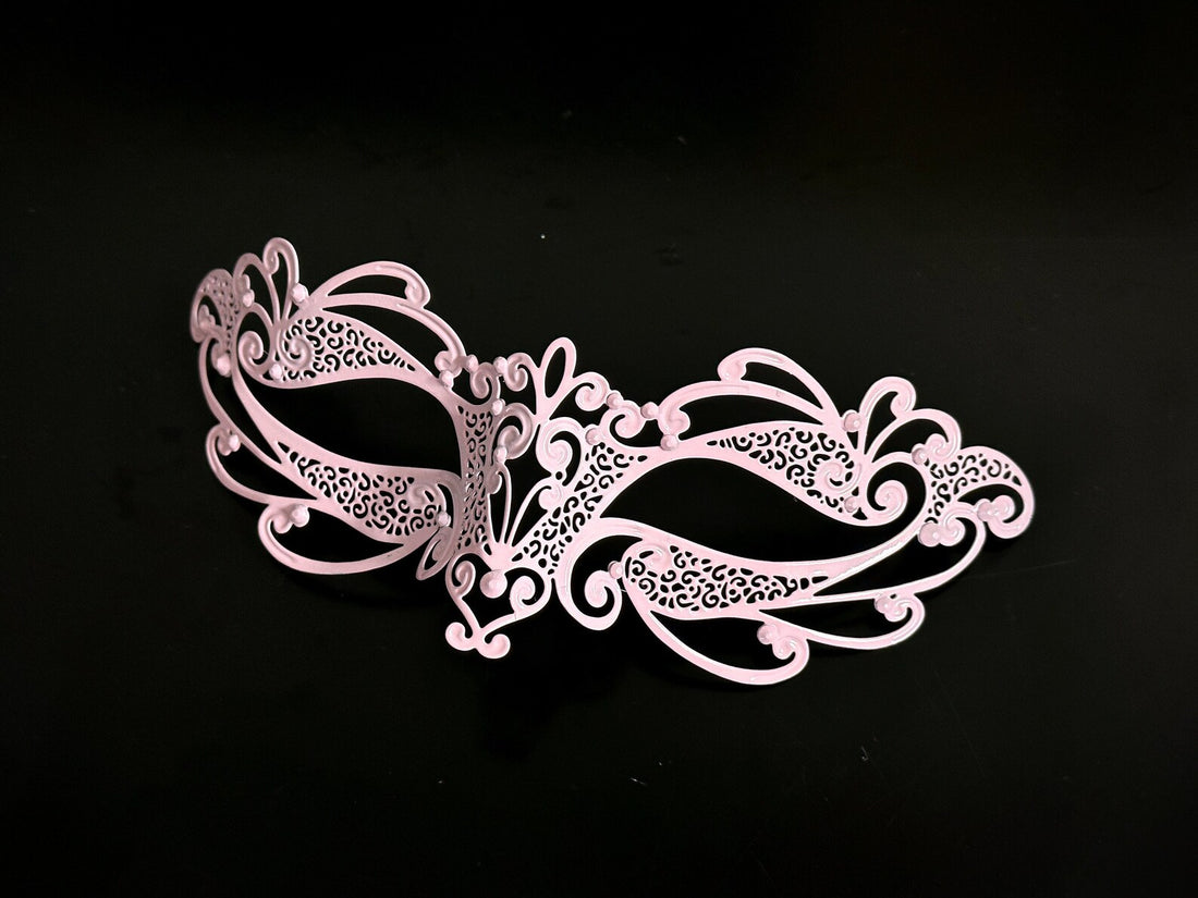 Delicate pink masquerade mask for kids with intricate cutout designs, perfect for costume parties or themed events.