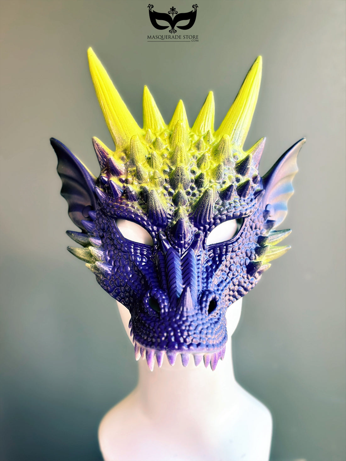 Purple yellow dragon masquerade mask with spiked horns and scales.