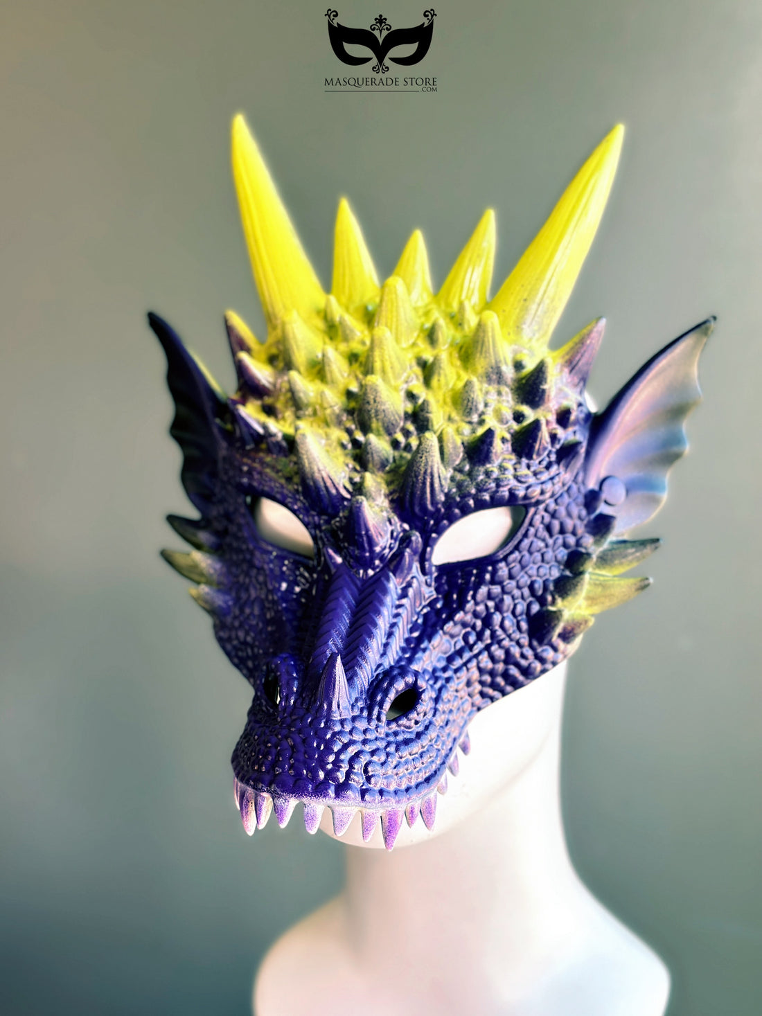 Purple yellow dragon masquerade mask with spiked horns and scales.