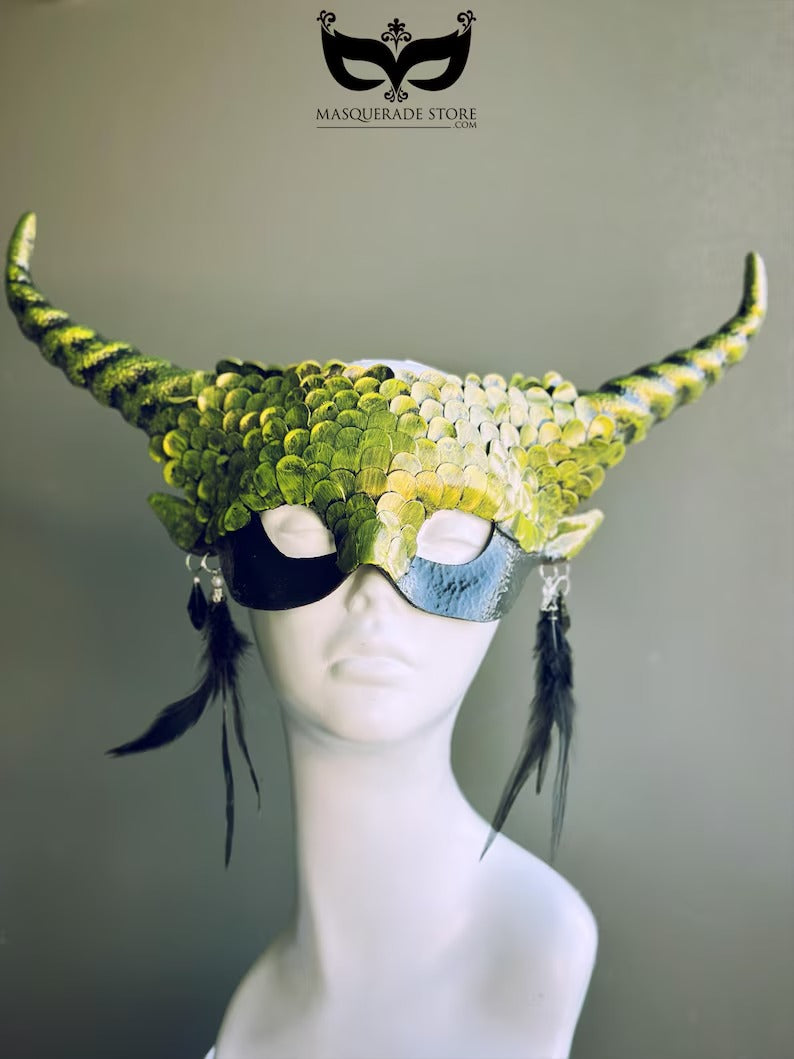 Green dragon horn masquerade mask with emerald scales, long horns, and feather accents, designed as a fantasy headdress.