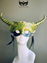 Green dragon horn masquerade mask with emerald scales, long horns, and feather accents, designed as a fantasy headdress.