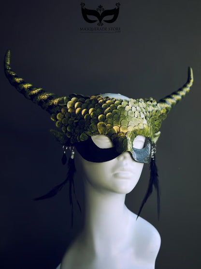Green dragon horn masquerade mask with emerald scales, long horns, and feather accents, designed as a fantasy headdress.