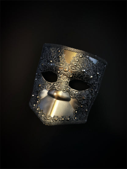 Venetian Bauta mask in gold and black with ornate lace overlay and crystal accents for an elegant, mysterious look.
