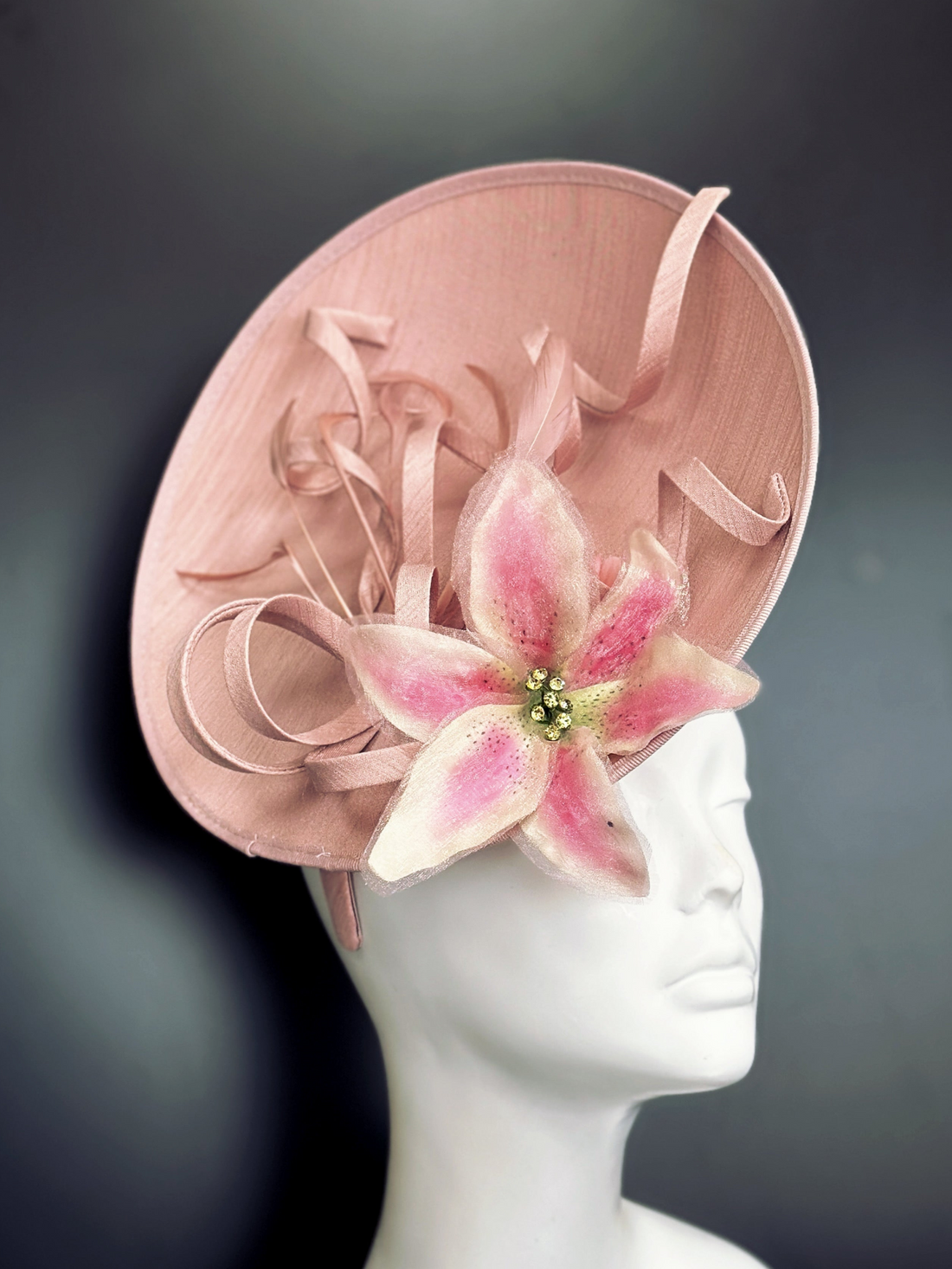 Pink fascinator hat base with pink florals.