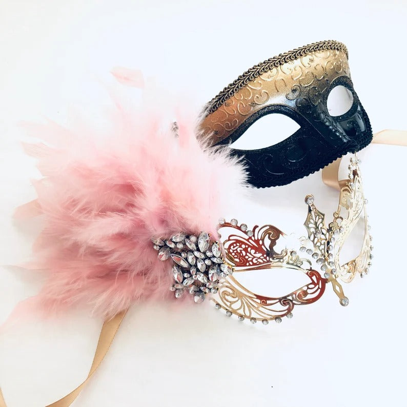 Gold and black men’s mask with matching girl’s gold filigree pink feather masquerade mask.