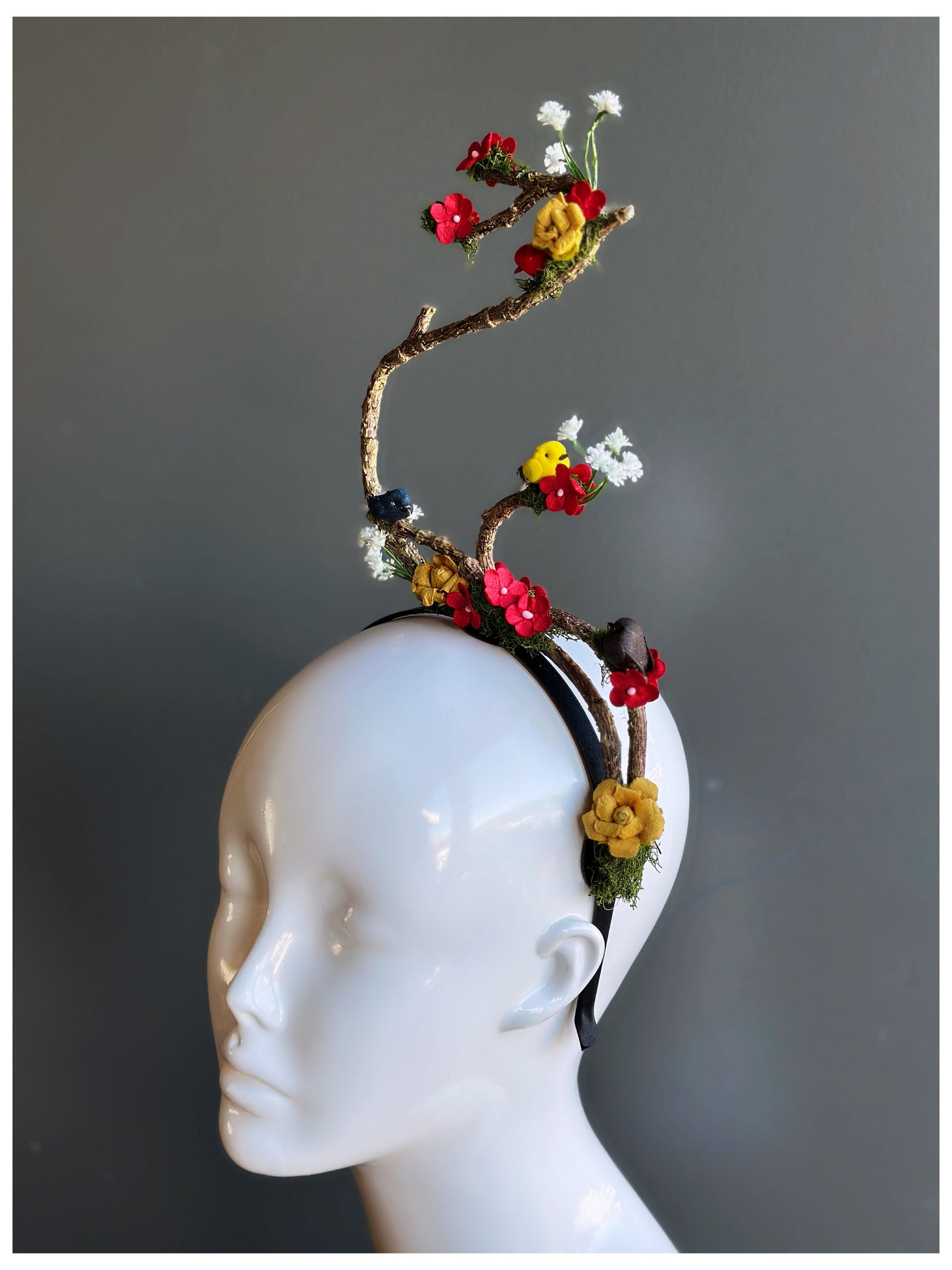 Artistic floral branch fascinator headband with flowers and birds.