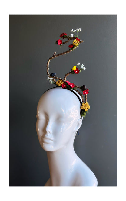 Artistic floral branch fascinator headband with flowers and birds.