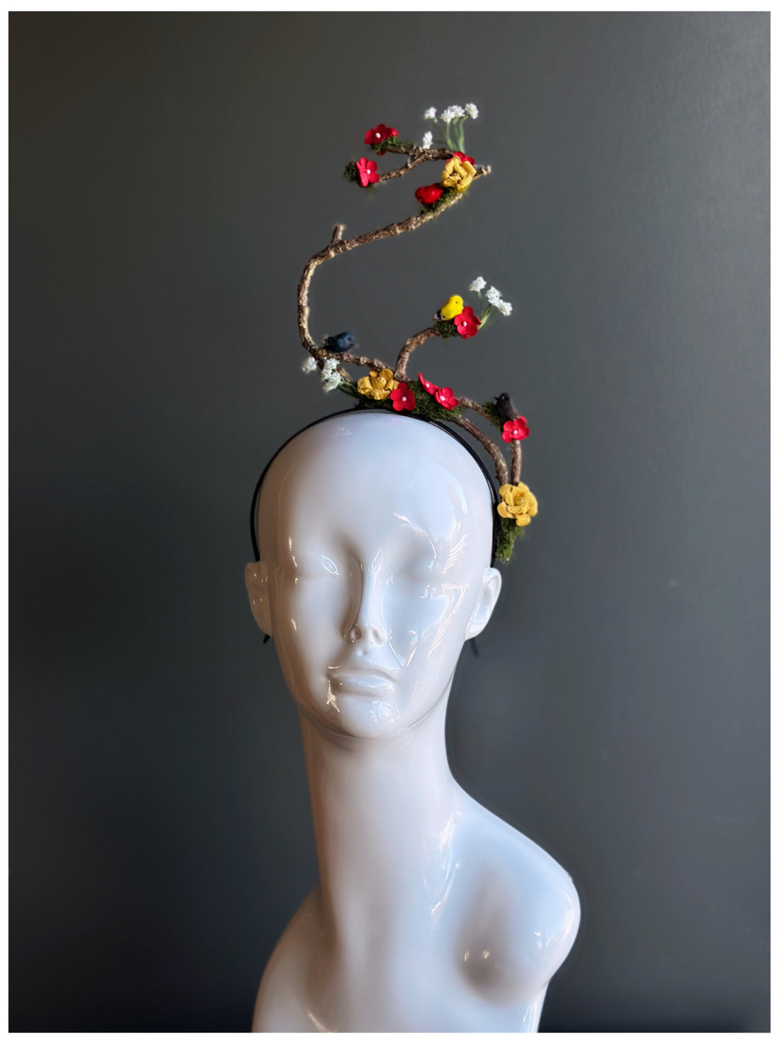 Artistic floral branch fascinator headband with flowers and birds.