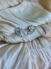 Floral earrings with crystal petals and a pearl center.