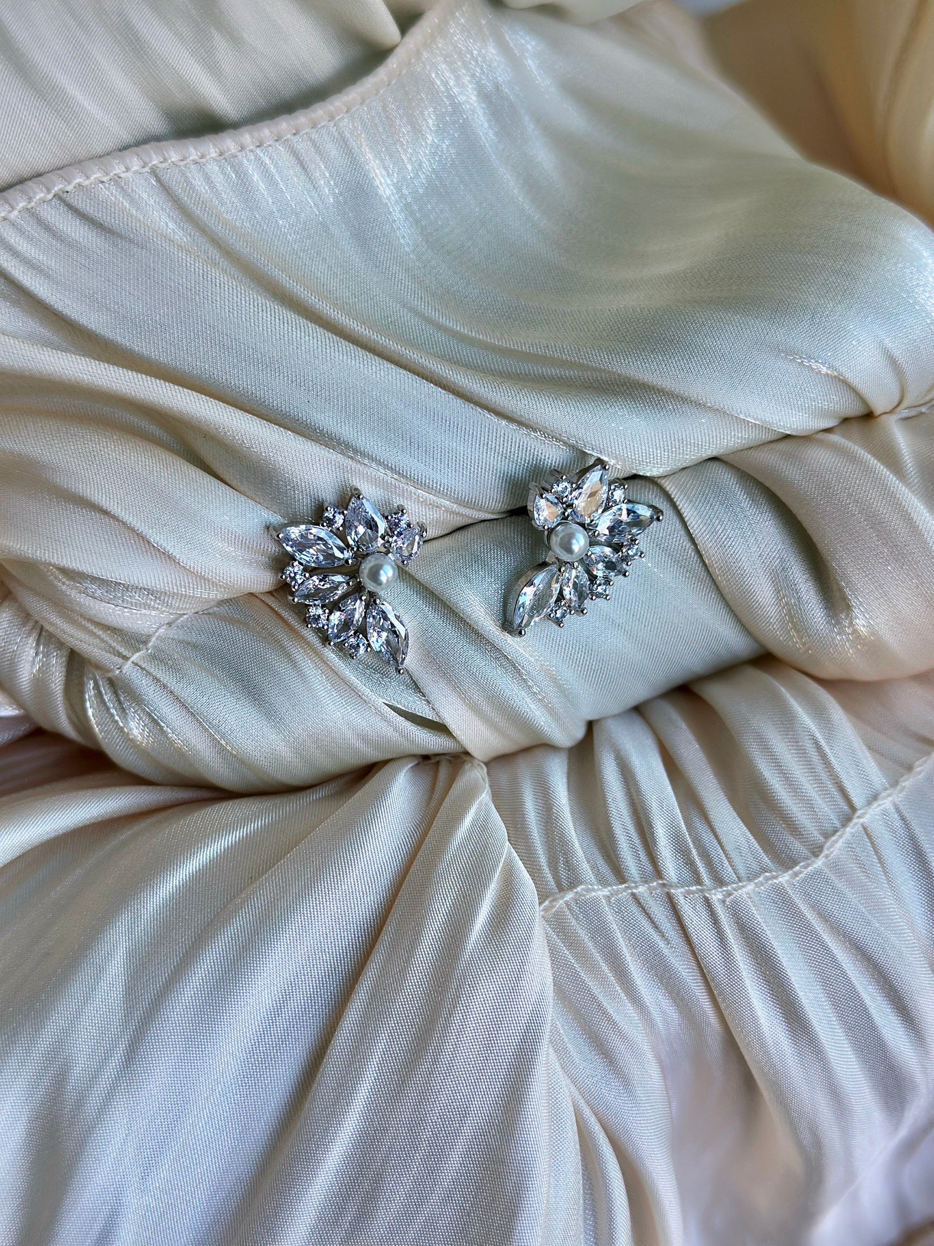 Floral earrings with crystal petals and a pearl center.