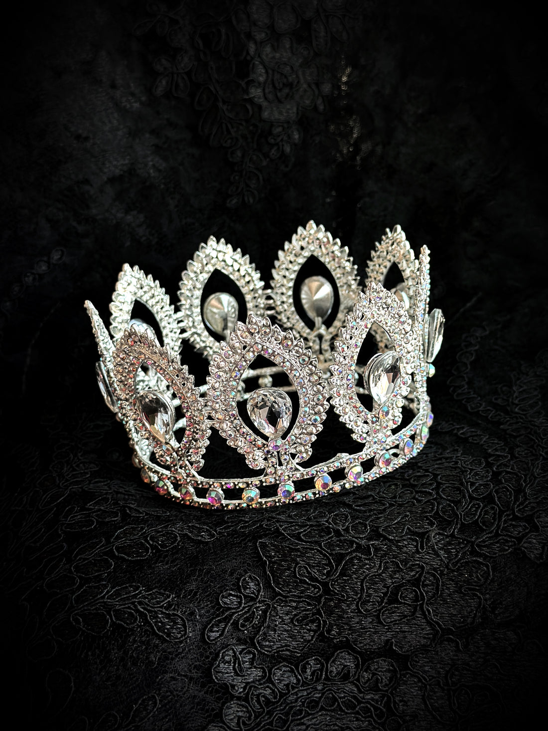 silver crown with clear crystal gems and intricate regal detailing