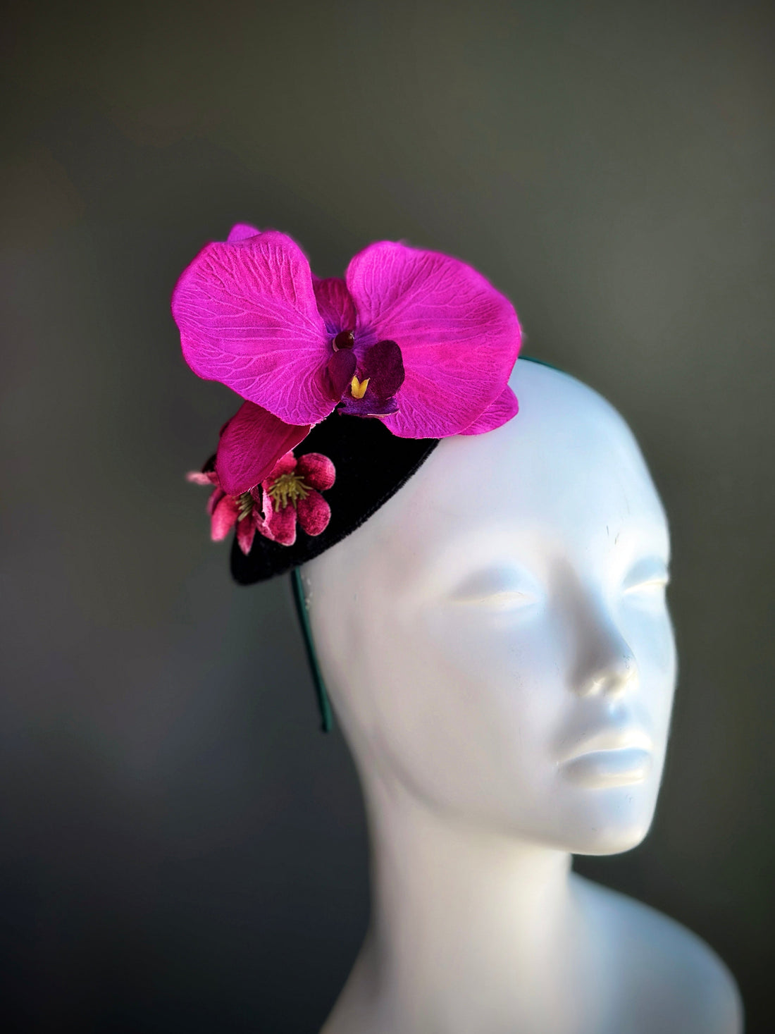 Fuchsia orchid fascinator hat with velvet base and pink flowers


