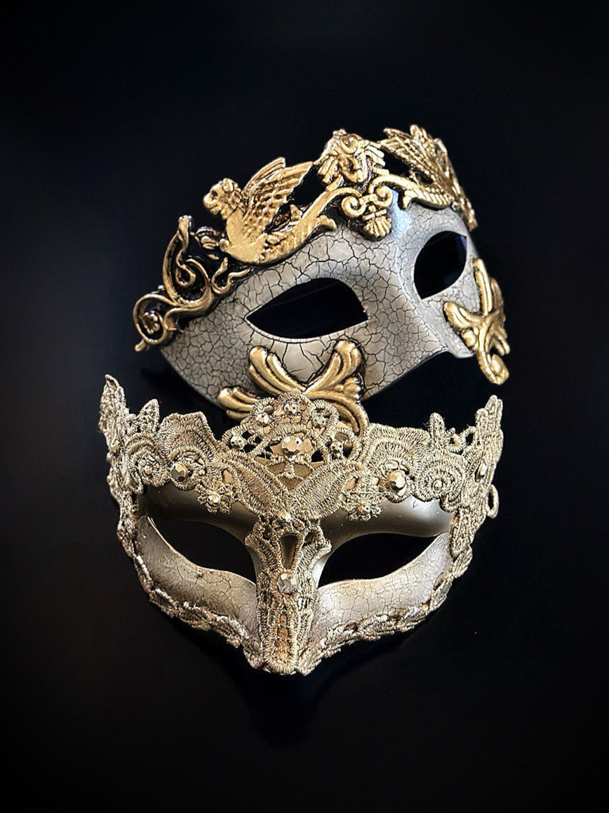 Couples masquerade masks in gold featuring a crackle gladiator design and a gold lace filigree mask for elegant events.
