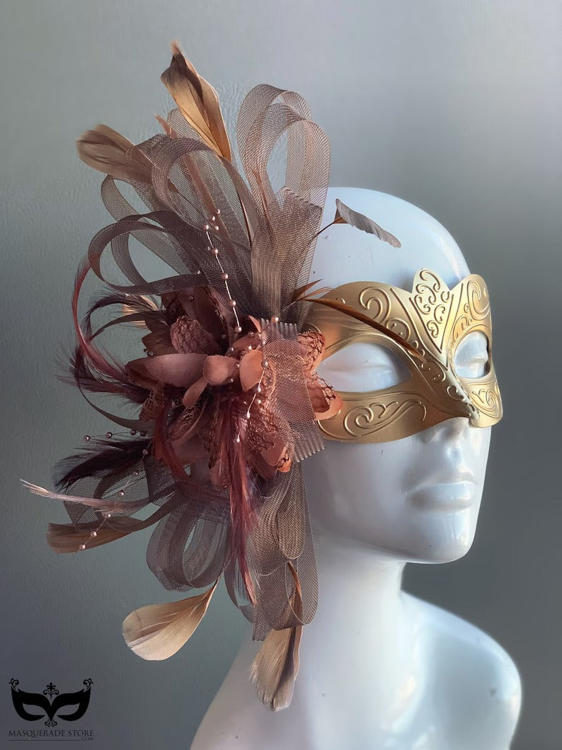 Gold mask with brown feathers and floral accents, designed for masquerade balls, proms, and Venetian carnivals.