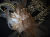 Elegant gold lace masquerade mask with feathers, rhinestones, and floral accents for women, ideal for balls and proms.