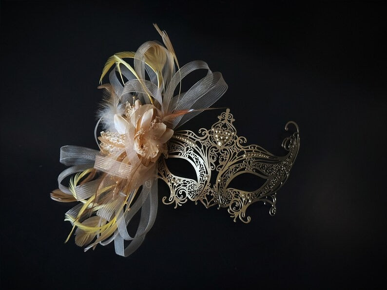 Elegant gold lace masquerade mask with feathers, rhinestones, and floral accents for women, ideal for balls and proms.