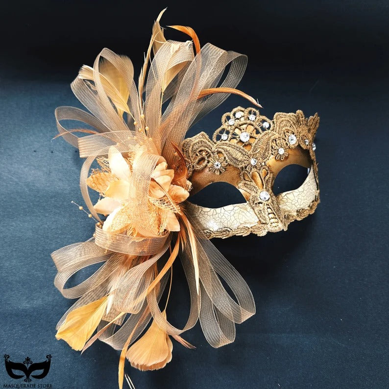 Elegant gold lace masquerade mask with feathers, rhinestones, and floral accents, perfect for weddings, proms, and masquerade balls.