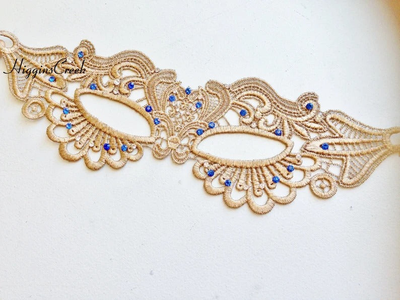 Elegant gold lace masquerade mask with blue rhinestone details for women