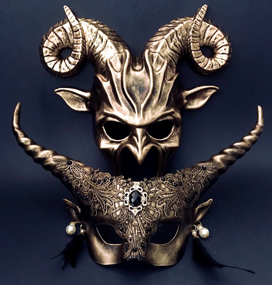 Gold gothic couples masquerade masks with horns and lace details.