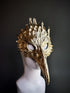 Golden bird mask with sculpted feather details and a long beak, perfect for masquerades, fantasy events, and theatrical performances.

