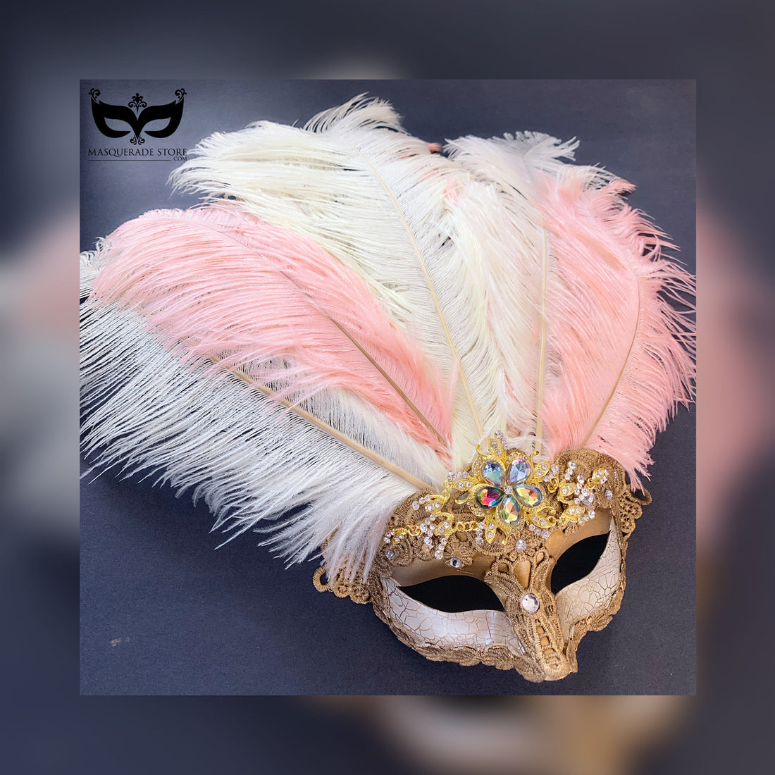 Golden mask adorned with blush and ivory ostrich feathers, gold lace, and sparkling rhinestones, ideal for glamorous events and masquerades.