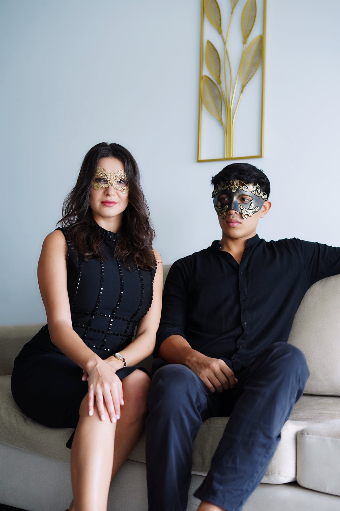 Couples masquerade masks in black and gold with ornate details and lace design.