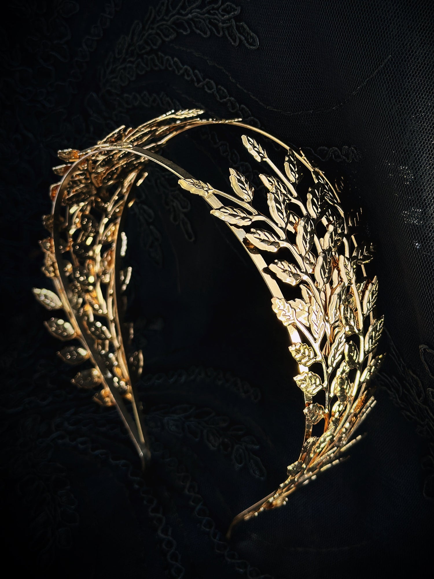 Gold Greek laurel leaf headband with layered metal leaves.