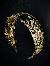 Gold Greek laurel leaf headband with layered metal leaves.