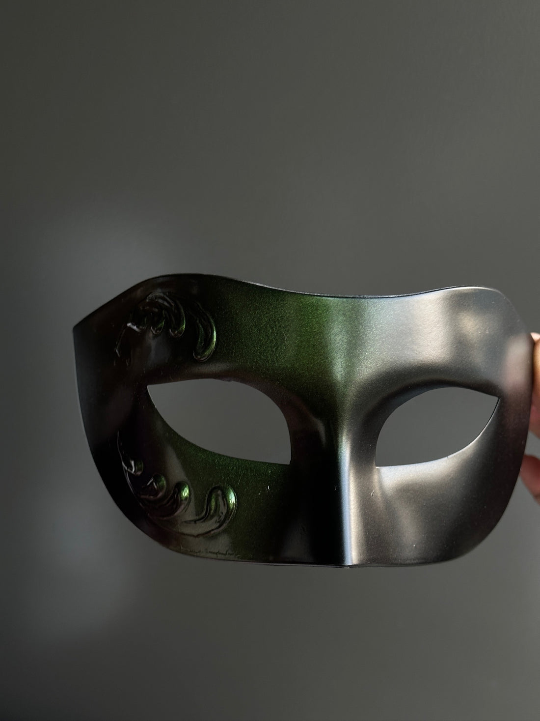 Green and black masquerade mask for men with embossed baroque scroll design and color-shifting finish