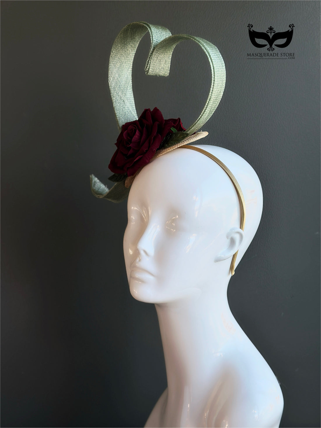 Green fascinator hat with heart shape and burgundy rose