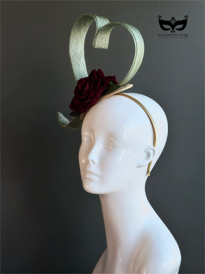 Green fascinator hat with heart shape and burgundy rose