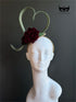 Green fascinator hat with heart shape and burgundy rose