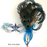 Venetian handheld masquerade mask with peacock feathers, jeweled details, and blue feather plumes.