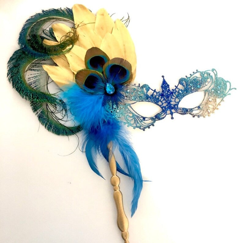 Venetian handheld masquerade mask with peacock feathers, jeweled details, and blue feather plumes.